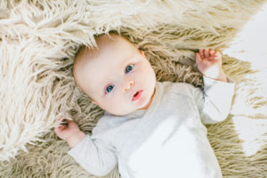 Baby on fluffy sheep's rug